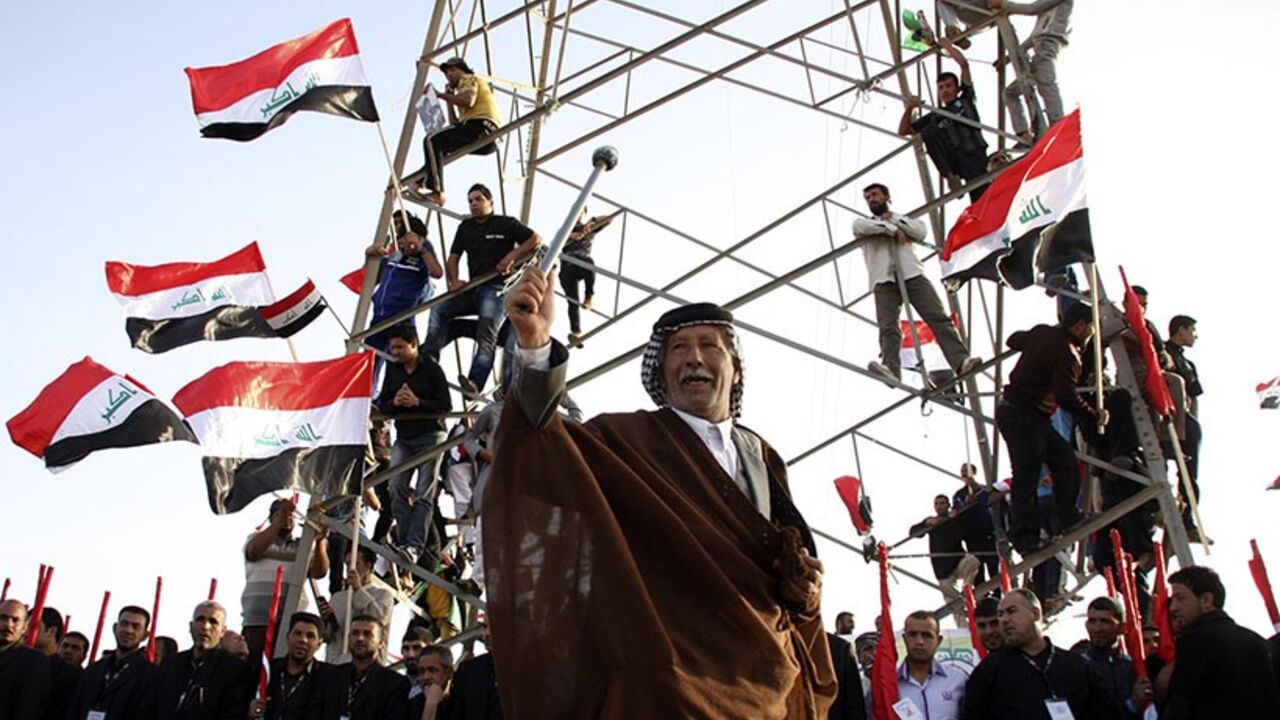 IRAQ/ A supporter of Shi'ite cleric Moqtada al-Sadr takes part in a rally, which the participants said was against sectarianism and injustice, in Kut, 150 km (93 miles) southeast of Baghdad, March 16, 2013. REUTERS/Wissm al-Okili (IRAQ - Tags: CIVIL UNREST TPX IMAGES OF THE DAY) - RTR3F2NB