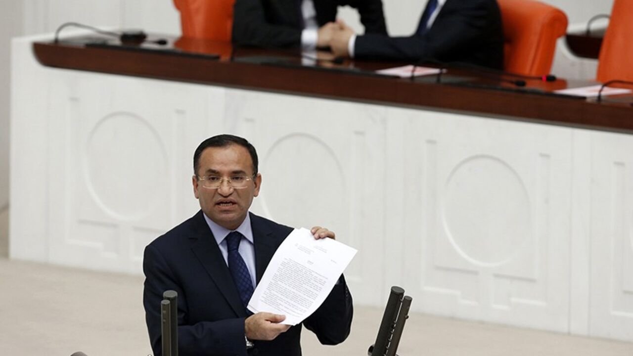 TURKEY/ Justice Minister Bekir Bozdag addresses the Turkish Parliament during a debate in Ankara March 19, 2014. Parliament convened in the capital Ankara for the hearing of a prosecutor report allegedly outlining the role of four former ministers in a corruption scandal that became public in December 2013. REUTERS/Umit Bektas (TURKEY - Tags: POLITICS) - RTR3HRDM