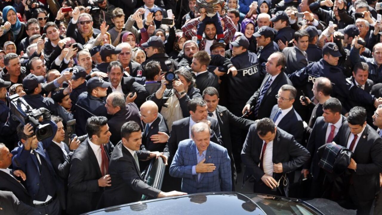 TURKEY-ELECTION/ Turkey's Prime Minister Tayyip Erdogan acknowledges supporters during the municipal elections outside a polling station in Istanbul March 30, 2014. Erdogan looks set to win Sunday's municipal elections that have become a crisis referendum on his 10-year rule as he tries to ward off graft allegations and stem a stream of damaging security leaks. REUTERS/Murad Sezer (TURKEY - Tags: POLITICS ELECTIONS) - RTR3J6TG