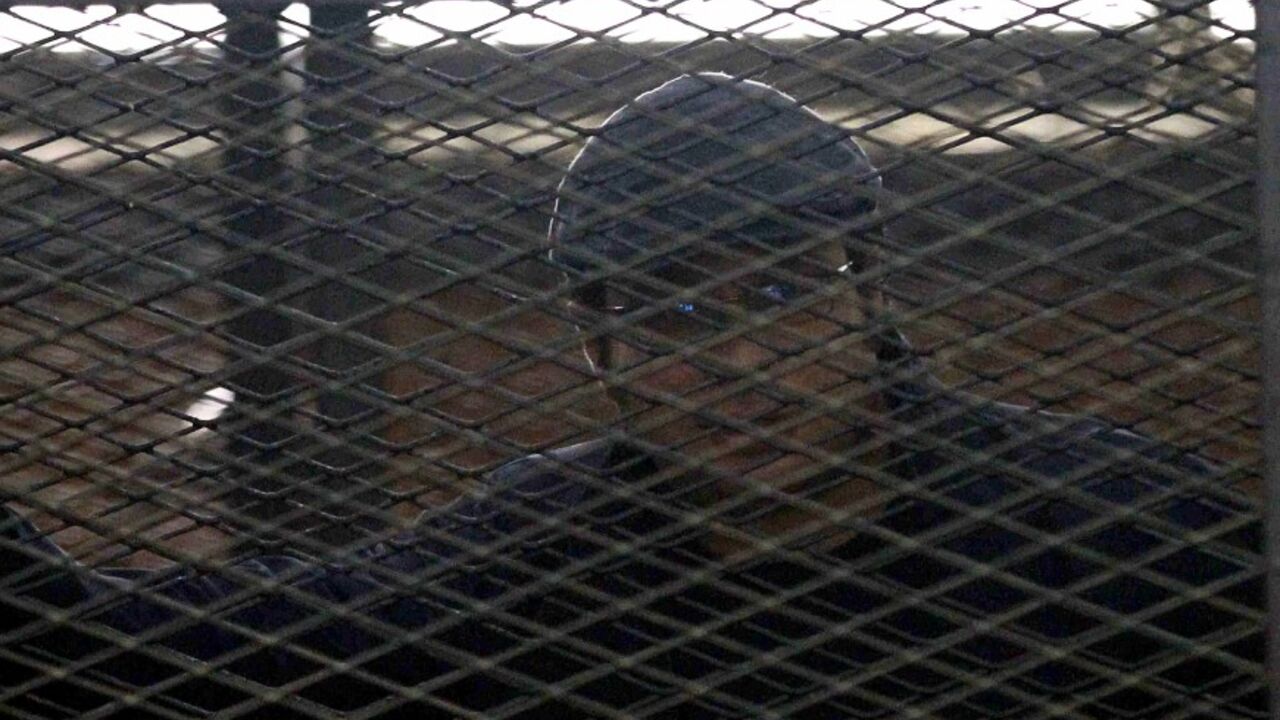 EGYPT-COURT/ACTIVISTS Activist Ahmed Maher stands behind bars at a court in Cairo April 7, 2014. An Egyptian appeals court on Monday upheld the jailing of three leading figures of the 2011 pro-democracy uprising, tightening a crackdown on secular activists opposed to the army-backed government. A court handed down three-year sentences on Monday to the three liberal activists, Ahmed Maher, Ahmed Douma and Mohamed Adel, last December for protesting without permission and assaulting the police. REUTERS/Al Youm Al Saabi Newspaper (E