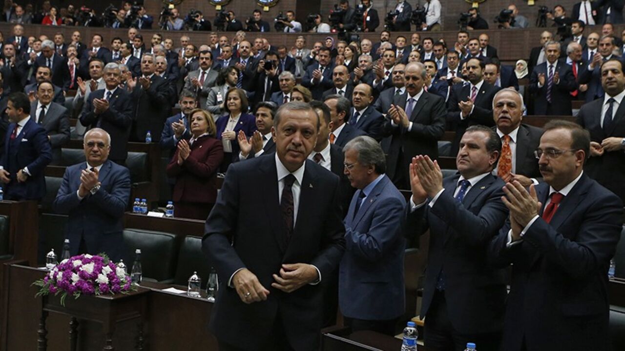 TURKEY-ERDOGAN/ Turkey's Prime Minister Tayyip Erdogan leaves his seat to address members of parliament from his ruling AK Party (AKP) during a meeting at the Turkish parliament in Ankara April 8, 2014. Turkey's first directly elected president will be a more powerful figure than the current largely ceremonial role, Prime Minister Tayyip Erdogan was quoted on Tuesday as saying, boosting expectations he may run for the post in August. Erdogan is barred by the rules of his ruling AK Party from standing for a fourth term as p