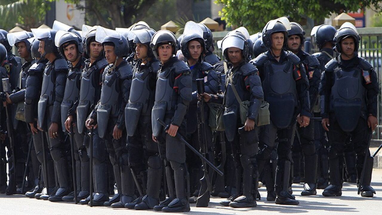 EGYPT/ Police officers take positions outside Cairo University during a protest inside by supporters of the Muslim Brotherhood and ousted Egyptian President Mohamed Mursi, in Cairo April 14, 2014. REUTERS/Mohamed Abd El Ghany (EGYPT - Tags: POLITICS CIVIL UNREST EDUCATION) - RTR3L8EV