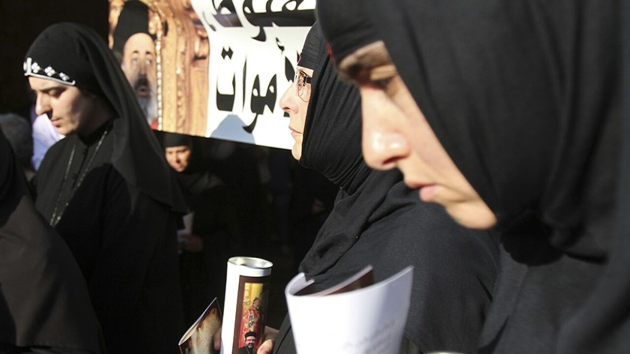 SYRIA-CRISIS/BISHOPS Nuns hold candles during a candle-lit vigil at the Balamand Monastery in Koura, near the north Lebanese city of Tripoli, to call for the release of bishops kidnapped in northern Syria two months ago, June 22, 2013. Greek Orthodox Patriarch John Yazigi led the candle-lit vigil on Saturday for Greek Orthodox archbishop Paul Yazigi and Syriac Orthodox archbishop Yohanna Ibrahim, appealing to their kidnappers to free them and urging Syrian security forces to do more to win their release. REUTERS/Omar Ibrahim (L