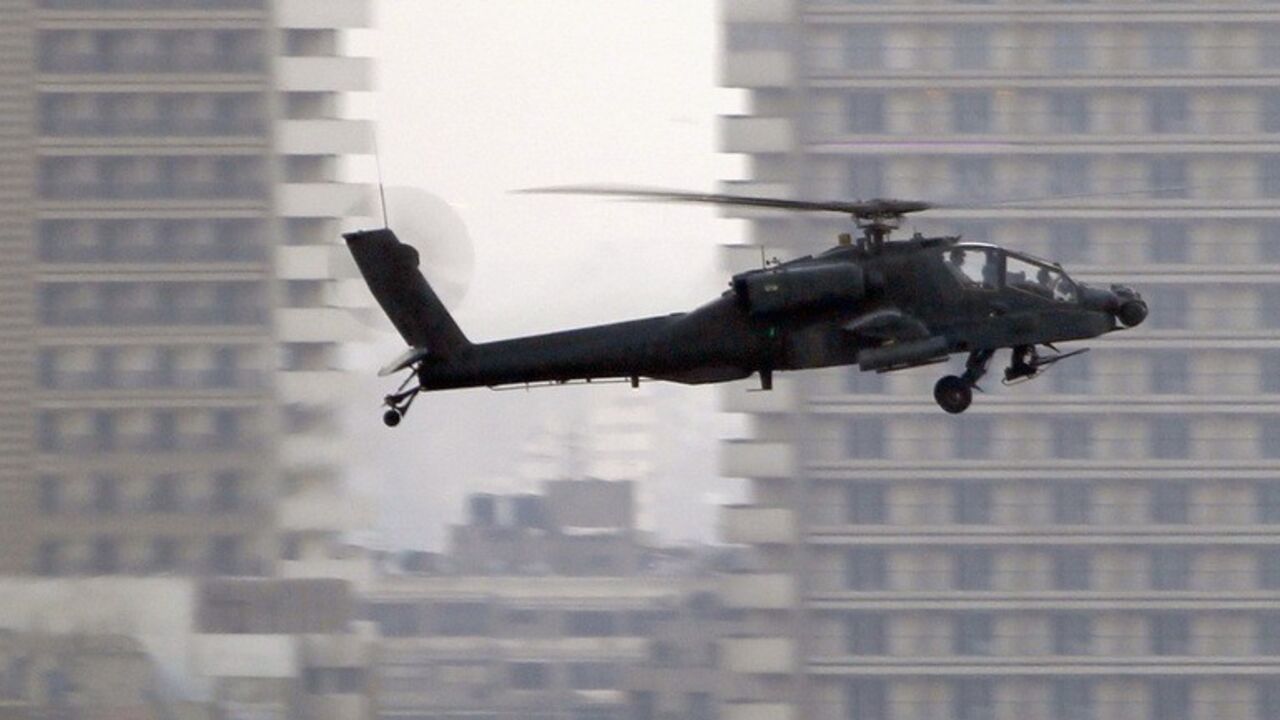 An Apache helicopter flies over Tahrir Square during a protest to support the army, in Cairo An Apache helicopter flies over Tahrir Square during a protest to support the army, in Cairo July 26, 2013. Ousted Egyptian president Mohamed Mursi is under investigation for an array of charges including murder, the state news agency said on Friday, stoking tensions as opposing political camps took to the streets. Confirming the potential for bloodshed, two men were killed in confrontations in Egypt's second city Alexandria and a further 19 were hurt, Mena news agency reported. REUTERS/Amr Abdallah Dalsh (