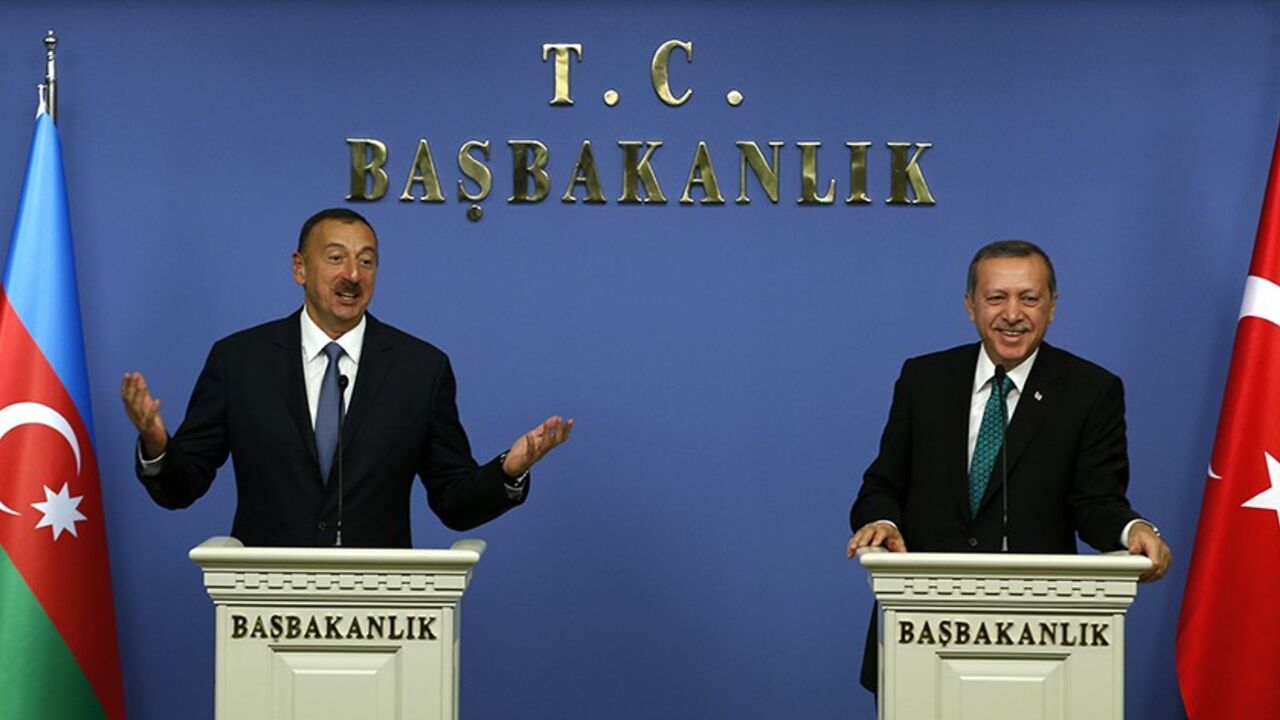 TURKEY-AZERBAIJAN/ Azerbaijan's President Ilham Aliyev (L) and Turkey's Prime Minister Tayyip Erdogan address the media in Ankara November 13, 2013. Erdogan said on Wednesday work on the Trans-Anatolian natural gas pipeline project (TANAP), which will carry Azeri natural gas, will begin in early 2014. Turkey, which has a 20 percent stake in TANAP, and Azerbaijan, which controls 80 percent, are looking at ways to cooperate on shipping Azeri gas to the Balkans, Erdogan also said after talks with Azeri President Ilham Aliyev in