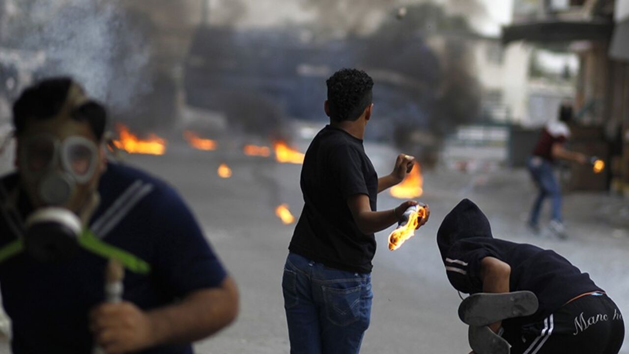 BAHRAIN-CLASHES/ Anti-government protesters throw petrol bombs towards riot police during clashes in the village of Diraz, west of Manama January 29, 2014. Bahraini police clashed with stone-throwing protesters in the village west of the capital, days after the funeral of a young man who died in custody, witnesses said. Wednesday's protest following the death of 20-year-old Fadhel Abbas threatened to sour a new attempt to restart negotiations between Bahrain's government, led by the ruling al-Khalifa family, and opposition