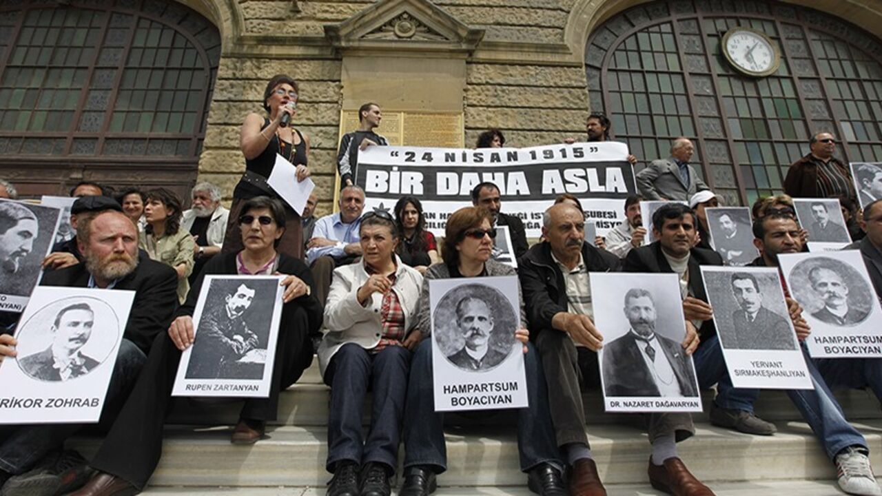 TURKEY-ARMENIA/ Human rights activists hold pictures of Armenian victims in front of the historical Haydarpasa station in Istanbul April 24, 2010, during a demonstration to commemorate the 1915 mass killing of Armenians in the Ottoman Empire. Muslim Turkey accepts many Christian Armenians died in partisan fighting beginning in 1915 but denies that up to 1.5 million were killed and that it amounted to genocide, a term used by some Western historians and foreign parliaments. Banner reads "Never again". REUTERS/ Osman Orsal