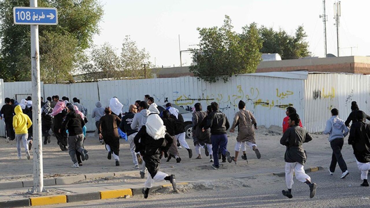 Nic6049467 Stateless Arabs, known as bidoon, run for cover as they take part in a demonstration to demand citizenship and other basic rights in Jahra, 50 kms (31 miles) northwest of Kuwait City, on January 14, 2012. Kuwaiti riot police on Saturday used tear gas and batons to disperse hundreds of stateless demonstrators for the second day in a row and arrested dozens, witnesses and a rights group said. AFP PHOTO/YASSER AL-ZAYYAT (Photo credit should read YASSER AL-ZAYYAT/AFP/Getty Images)