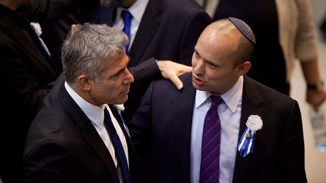 73162680 JERUSALEM, ISRAEL - FEBRUARY 05: Yair Lapid leader of the Israeli Yesh Atid party (L) and Naftali Bennett, head of Israel's Jewish Home party attend the swearing-in ceremony of the 19th Knesset, the new Israeli parliament, on February 5, 2013 in Jerusalem, Israel. The 120 members included a record 48 new law makers. (Photo by Uriel Sinai/Getty Images)