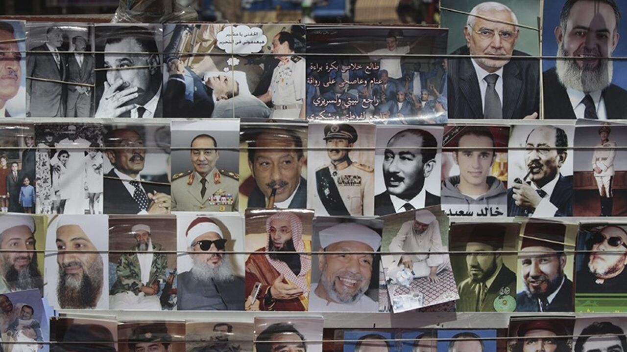 EGYPT Pictures, including images depicting former Egyptian president Hosni Mubarak and members of his regime, Presidential candidates and some various former leaders, are seen at Tahrir Square in Cairo April 26, 2012. Egypt's election committee announced on Thursday the list of 13 candidates for the presidential election which will be held on May 23 and 24. REUTERS/Amr Abdallah Dalsh (EGYPT - Tags: POLITICS ELECTIONS) - RTR3197T