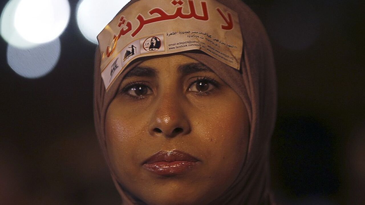 EGYPT/ A woman wearing a sign on her head that reads "No Harassment" takes part in a protest against Egypt's President Mohamed Mursi and the Muslim Brotherhood and in support of women rights in the constitution in front of the presidential palace in Cairo October 4, 2012. REUTERS/Amr Abdallah Dalsh (EGYPT - Tags: POLITICS CIVIL UNREST) - RTR38T3N