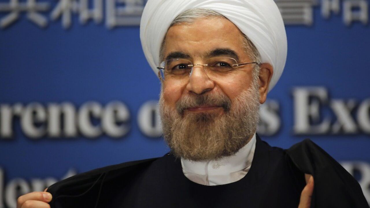 Iran's President Hassan Rouhani smiles as he leaves a news conference at a hotel after the fourth CICA summit, in Shanghai Iran's President Hassan Rouhani smiles as he leaves a news conference at a hotel after the fourth Conference on Interaction and Confidence Building Measures in Asia (CICA) summit, in Shanghai May 22, 2014. Rouhani said on Thursday he is not pessimistic about reaching an agreement over nuclear talks with the United States, Russia, China, France, Britain and Germany. REUTERS/Carlos Barria (CHINA - Tags: POLITICS) - RTR3QAZK