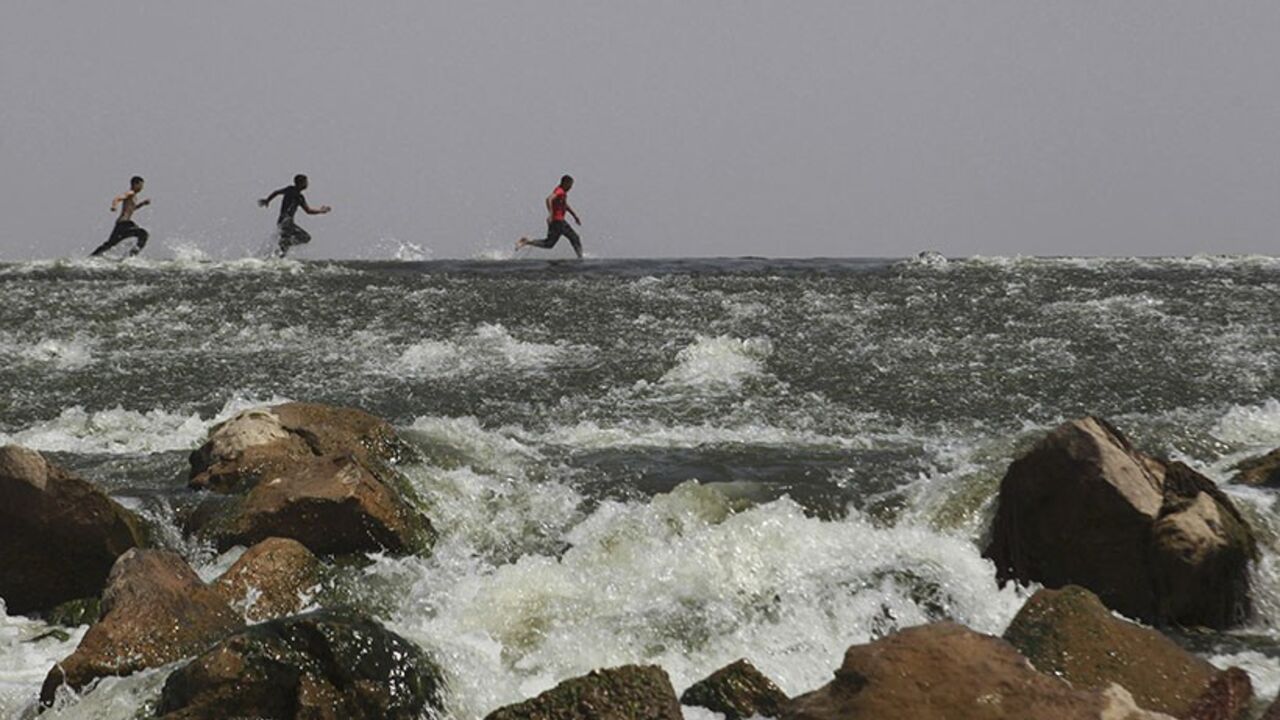 EGYPT/ Boys run in the river Nile on the outskirts of Cairo May 6, 2013. Most of Egypt's population live clustered around the Nile valley and delta, and the river is both a vital resource for the country's citizens, and a potent national symbol. In a recent dispute with Ethiopia over the construction of a dam upstream, Egypt's foreign minister Mohamed Kamel Amr underlined the country's reliance on the river's waters: "No Nile - no Egypt," he said. Picture taken May 6, 2013. REUTERS/Asmaa Waguih (EGYPT - Tags: POLI