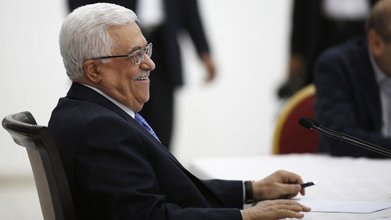 PALESTINIANS-ISRAEL/KERRY Palestinian President Mahmoud Abbas smiles during a meeting of the Palestinian leadership in the West Bank city of Ramallah July 18, 2013. As Palestinian leaders discussed a possible U.S-brokered resumption of peace talks on Thursday, the Israeli government denied a shift in its conditions that might help end a three-year stalemate. Abbas began briefing fellow PLO leaders in Ramallah on his meetings this week with U.S. Secretary of State John Kerry, who has extended his stay in the region and appears to be