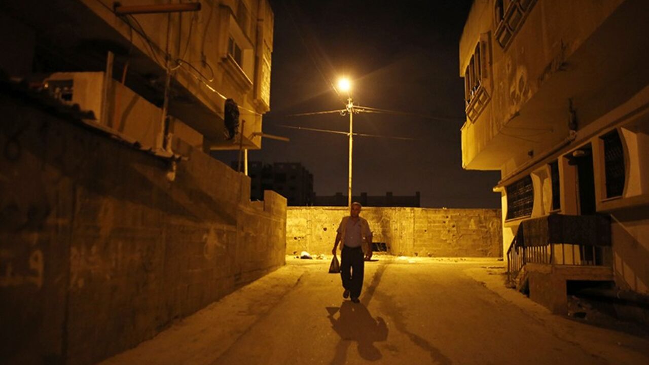 PALESTINIANS-ISRAEL/ Taysir Sharif Abu Hader, a 57-year-old Palestinian labourer who has a permit to work in Israel, starts his journey to Israel from the West Bank town of Qalqilya June 30, 2013. There are two ways for Palestinian workers to cross into Israel every day. Those with work permits can pass through a military checkpoint. Those without have to find a way through the separation barrier, which is made up of mostly fences and some cement walls, snaking its way through the West Bank. Those caught entering illegally risk