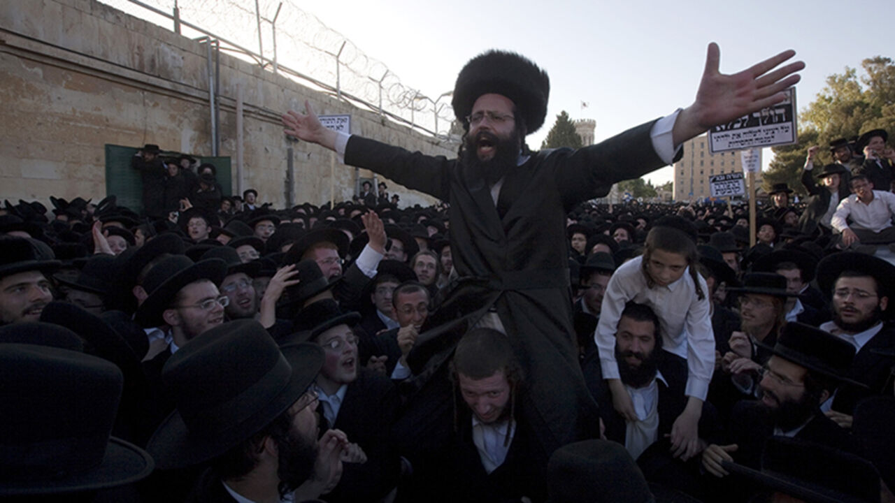 An Ultra-Orthodox Jewish man is carried An Ultra-Orthodox Jewish man is carried on the shoulders by his friends in an "honor gesture" into the Jerusalem central police station on his way to prison, as tens of thousands of religious Israelis protested on June 17, 2010 against a Supreme Court ruling which ordered the jailing of a group of Ashkenazi parents of European origin who have refused to send their daughters to a school with Jewish girls of Middle Eastern, or Sephardic, descent. AFP PHOTO/MENAHEM KAHANA (Photo credit should read MENAHEM KAH