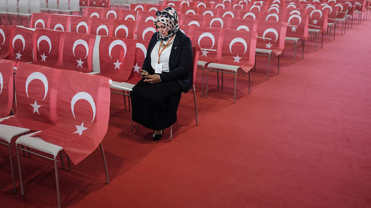 AUSTRIA-TURKEY-POLITICS-ERDOGAN A woman wearing a head scarf checks her mobile device as she awaits the speech of the Turkish Prime Minister during an event to mark the 10th anniversary of the Union of European Turkish Democrats UETD at the Albert Schultz Hall in Vienna, Austria on June 19, 2014. Austria warned the Turkish Prime Minister on June 12, 2014 not to say anything that may "split" Austrian society during his visit.
AFP PHOTO / PATRICK DOMINGO (Photo credit should read Patrick Domingo/AFP/Getty Images)