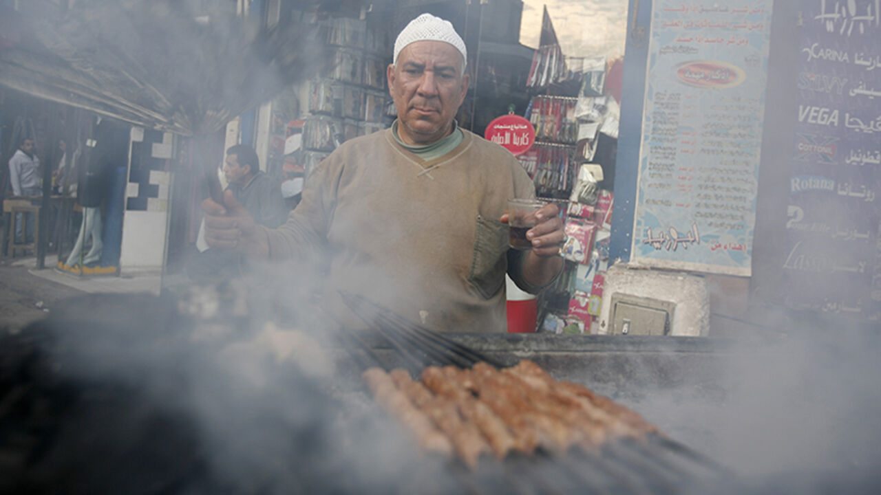 A man grills kebab in Cairo A man grills kebab, which is used to prepare sandwiches for passers-by, along a street corner in Cairo February 23, 2010. REUTERS/Asmaa Waguih(EGYPT - Tags: FOOD SOCIETY) - RTR2AROO