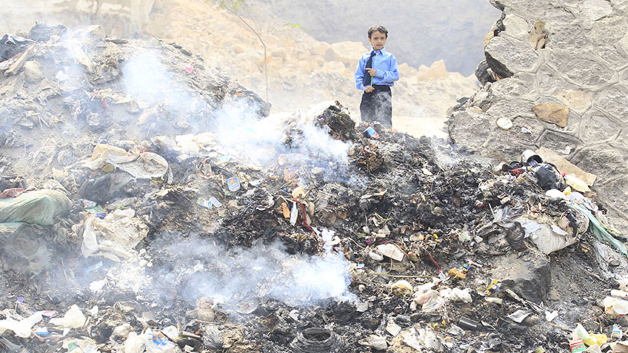 A child living in the shanty area of al-Dweiqa walks past smouldering rubbish as he makes his way home from school in Cairo A child living in the shanty area of al-Dweiqa walks past smouldering rubbish as he makes his way home from school in Cairo October 4, 2012. Egyptian President Mohamed Mursi has won grudging respect from detractors in his first 100 days by sending the army back to barracks faster than anyone expected and raising Egypt's international profile in several newsmaking visits abroad. Yet his political fortunes and those of the Muslim Brotherhood which propelled him to power may well depend on his delivering on mo