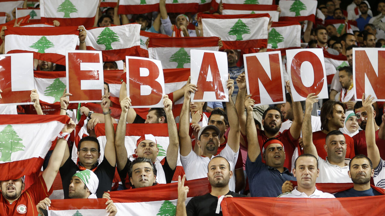 Fans of Lebanon cheer their team during their 2014 World Cup qualifying soccer match against Qatar in Doha Fans of Lebanon cheer their team during their 2014 World Cup qualifying soccer match against Qatar in Doha, November 14, 2012. REUTERS/Fadi Al-Assaad (QATAR - Tags: SPORT SOCCER) - RTR3AEDG