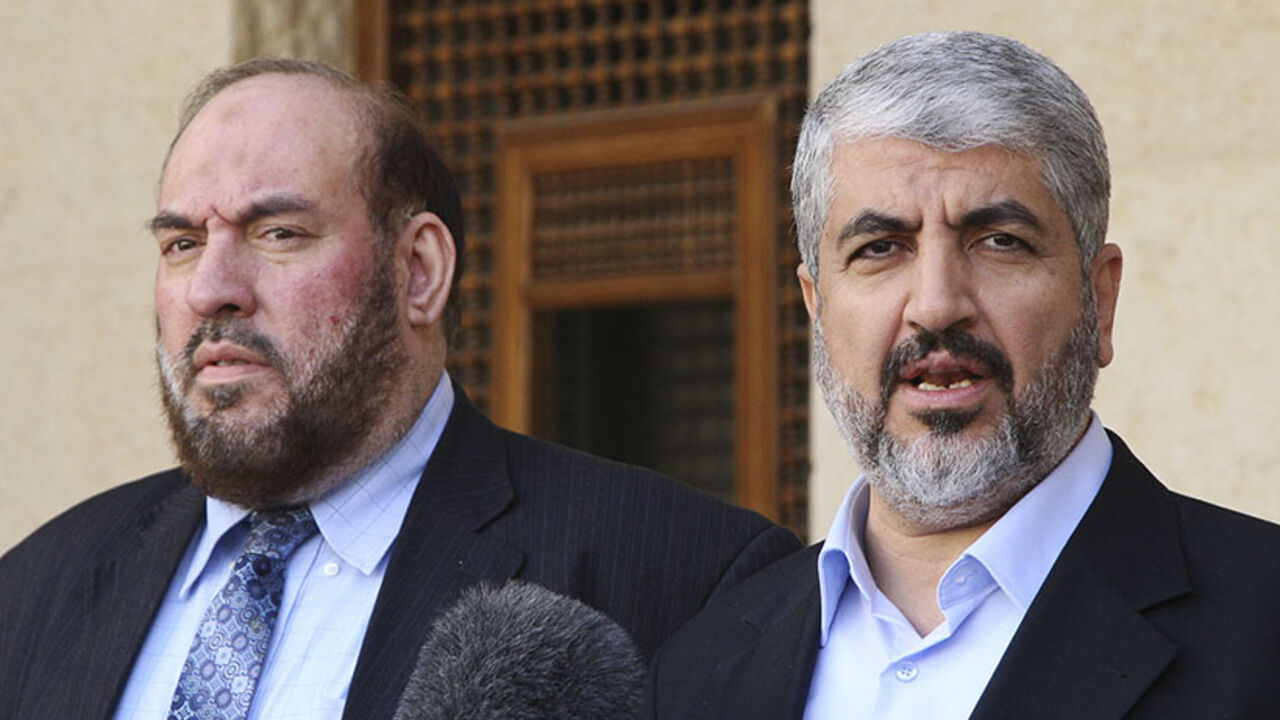 Hamas leader Meshaal and Nazzal, a member of the Hamas leadership, speak to media after their meeting with Jordan's King Abdullah in Amman Hamas leader Khaled Meshaal (R) and Mohammad Nazzal, a member of the Hamas leadership, speak to media after their meeting with Jordan's King Abdullah at the Royal Palace in Amman January 28, 2013. REUTERS/Majed Jaber (JORDAN - Tags: POLITICS) - RTR3D30A