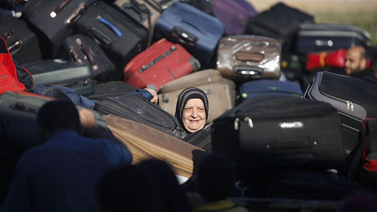 Palestinian passenger, hoping to cross into Egypt, searches for bag as she waits at Rafah crossing, between Egypt and southern Gaza Strip A Palestinian passenger, hoping to cross into Egypt, searches for her bag as she waits at the Rafah crossing, between Egypt and the southern Gaza Strip, September 30, 2013. Egypt partially reopened its border crossing with the Gaza Strip for three days on Saturday for the humanitarian needs of patients seeking treatment, and students studying outside of Gaza, a Palestinian official said. REUTERS/Ibraheem Abu Mustafa (GAZA - Tags: POLITICS SOCIETY IMMIGRATION TPX IMAGES OF THE DAY) - RTR3FFFU