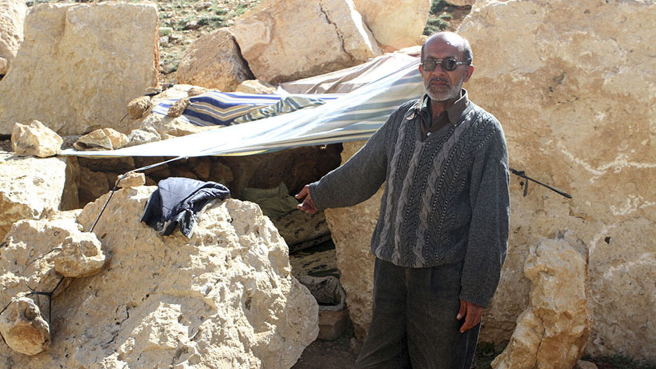 A Syrian refugee points at his make-shift home in Tfail village in Bekaa Valley after fleeing the violence in Syria A Syrian refugee points at his make-shift home in Tfail village in Bekaa Valley after fleeing the violence in Syria, April 22, 2014. The only accessible road to the Lebanese border village of Tfail, cut off by Syrian regime troops as part of the regime's offensive to root out rebels in the Qalamoun region, was reopened on Tuesday by the Lebanese Army. REUTERS/Ahmad Shalha (LEBANON - Tags: POLITICS CIVIL UNREST) - RTR3M9R6