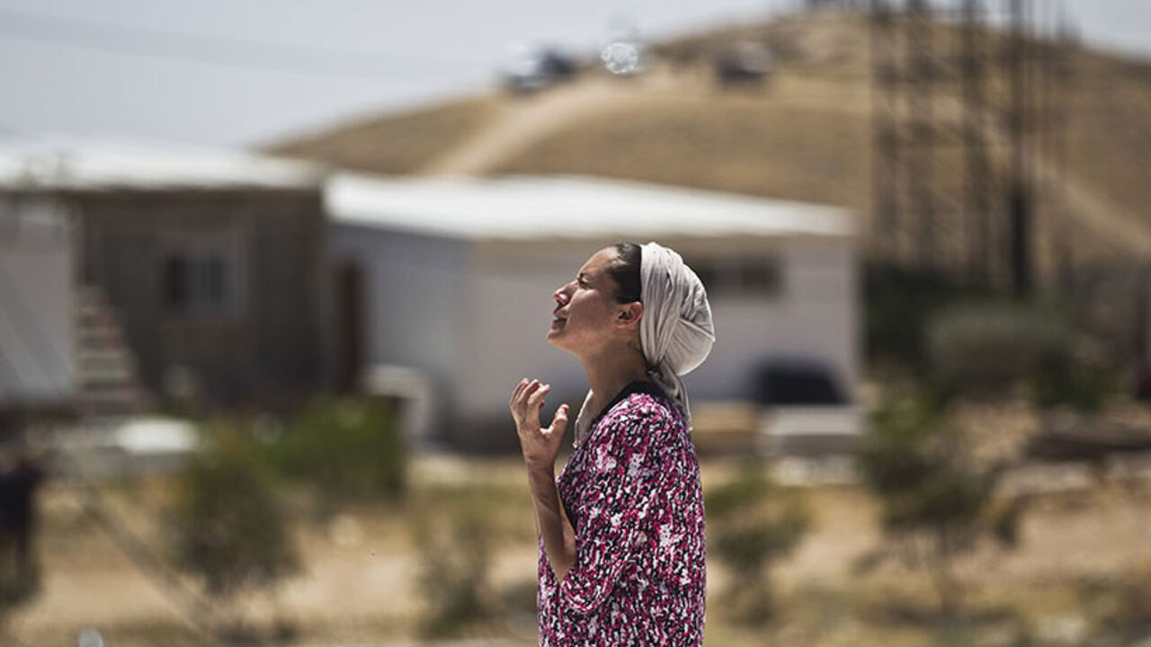 A Jewish settler reacts as she stands atop the roof of a temporary structure before Israeli policemen demolish it in the West Bank Jewish settler outpost of Maale Rehavam, near Bethlehem A Jewish settler reacts as she stands atop the roof of a temporary structure before Israeli policemen demolish it in the West Bank Jewish settler outpost of Maale Rehavam, near Bethlehem May 14, 2014. Some seven structures were razed on Wednesday by Israeli border police officers and no injuries or arrests were made during the incidences, a police spokesman said on Wednesday. The structures were demolished as part of Israel's continuing effort to remove settlements built without government authorization. R