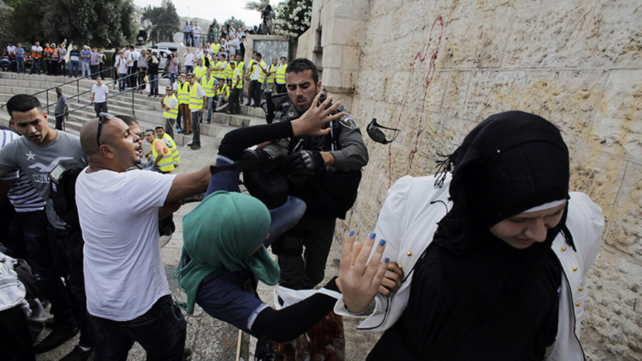 An Israeli border policeman scuffles with a Palestinian woman during clashes at a protest in Jerusalem's Old City An Israeli border policeman scuffles with a Palestinian woman during clashes at protest against a parade by Israelis marking Jerusalem Day, near Damascus Gate in Jerusalem's Old City May 28, 2014. Nine Palestinians were detained on suspicion of throwing stones at policemen and participants of the parade, an Israeli police spokesman said on Wednesday. Jerusalem Day marks the anniversary of Israel's capture of the Eastern part of the city during the 1967 Middle East War. In 1980, Israel's parliament passed a