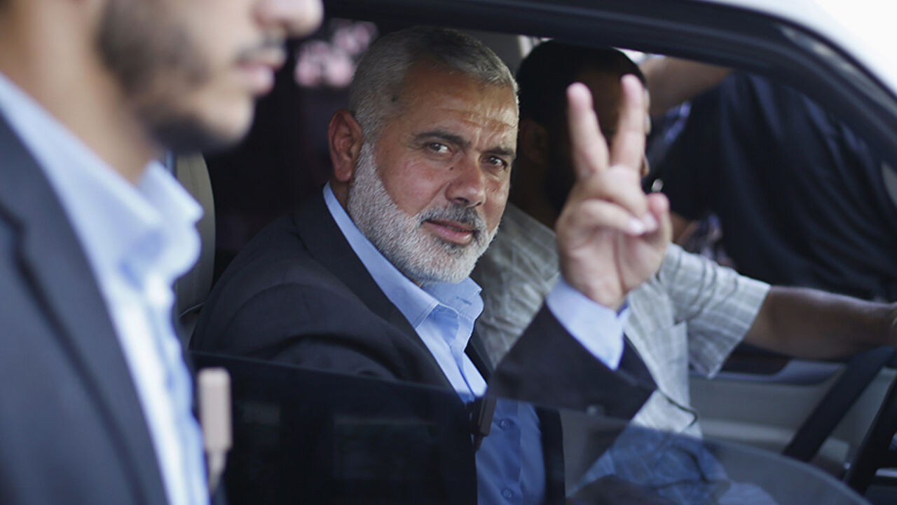 Senior Hamas leader Ismail Haniyeh gestures as leaves his office as a former Hamas government Prime Minister, in Gaza City Senior Hamas leader Ismail Haniyeh gestures as leaves his office as a former Hamas government Prime Minister, in Gaza City June 2, 2014. President Mahmoud Abbas swore in a Palestinian unity government on Monday under a reconciliation deal with Hamas Islamists that led Israel to freeze U.S.-brokered peace talks with the Western-backed leader. REUTERS/Suhaib Salem (GAZA - Tags: POLITICS) - RTR3RTYV