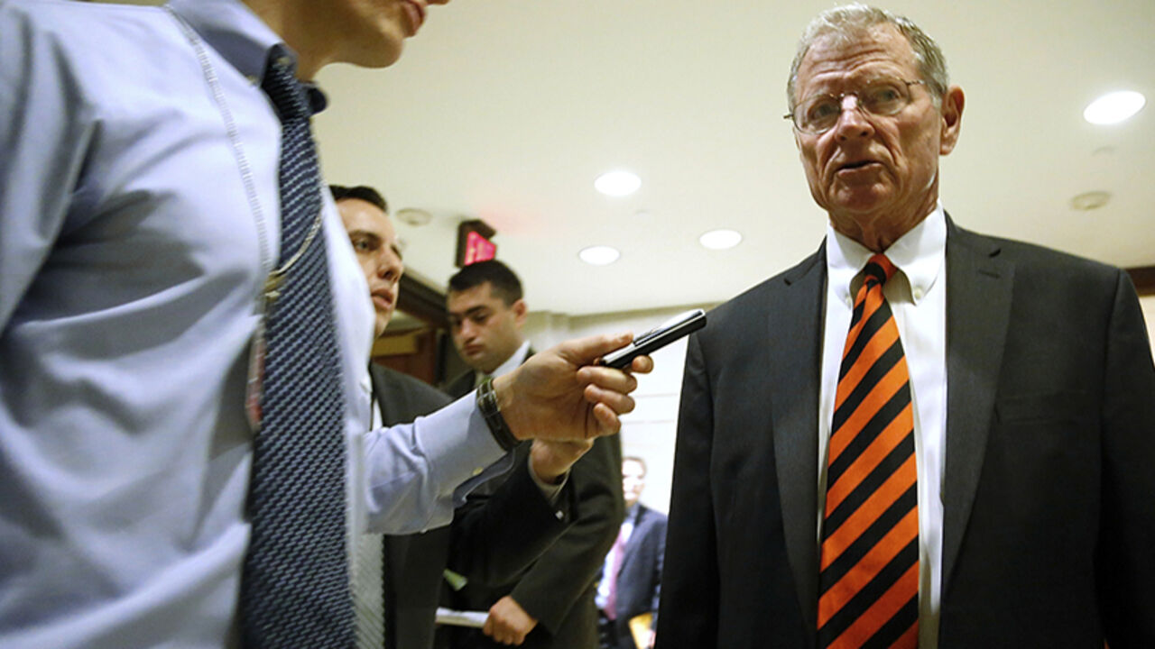 Inhofe is trailed by reporters outside of a closed-door Senate Armed Services Committee briefing on the Bergdahl prisoner swap at the U.S. Capitol in Washington Senator James Inhofe (R-OK) (R) is trailed by reporters outside of a closed-door Senate Armed Services Committee briefing on the Bergdahl prisoner swap at the U.S. Capitol in Washington June 10, 2014. The White House has been trying to appease angry lawmakers since U.S. President Barack Obama announced on May 31 that U.S. Army Sergeant Bowe Bergdahl had been exchanged for the five inmates from the U.S. military prison at Guantanamo Bay in Cuba. REUTERS/Jonathan Ernst (UNITED STATES - Tags: POLITICS MILITARY