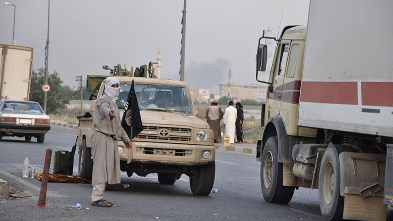 Fighters of the Islamic State of Iraq and the Levant (ISIL) stand guard at a checkpoint in the northern Iraq city of Mosul Fighters of the Islamic State of Iraq and the Levant (ISIL) stand guard at a checkpoint in the northern Iraq city of Mosul, June 11, 2014. Since Tuesday, black clad ISIL fighters have seized Iraq's second biggest city Mosul and Tikrit, home town of former dictator Saddam Hussein, as well as other towns and cities north of Baghdad. They continued their lightning advance on Thursday, moving into towns just an hour's drive from the capital. Pictures taken June 11, 2014. REUTERS/Stringer (IRAQ - Tags: CIVIL UNR