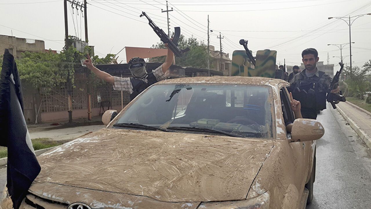 Fighters of the Islamic State of Iraq and the Levant (ISIL) celebrate on vehicles taken from Iraqi security forces, at a street in city of Mosul Fighters of the Islamic State of Iraq and the Levant (ISIL) celebrate on vehicles taken from Iraqi security forces, at a street in city of Mosul, June 12, 2014. Since Tuesday, black clad ISIL fighters have seized Iraq's second biggest city Mosul and Tikrit, home town of former dictator Saddam Hussein, as well as other towns and cities north of Baghdad. They continued their lightning advance on Thursday, moving into towns just an hour's drive from the capital. Picture taken June 12, 2014. REUTERS/Stringer (I