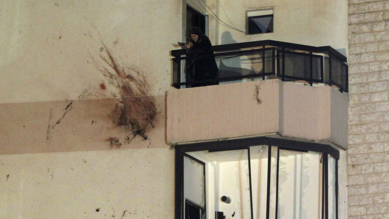 A woman stands on a balcony as she removes shattered glass beside bloodstains on the wall of a building at a site of an explosion in the southern suburbs of Beirut A woman stands on a balcony as she removes shattered glass beside bloodstains on the wall of a building at a site of an explosion in the southern suburbs of the Lebanese capital Beirut, early June 24, 2014. A suicide bomber blew up his car in southern Beirut on Monday night near an army checkpoint, killing himself and wounding several people watching the soccer World Cup in a nearby cafe. REUTERS/Mohamed Azakir (LEBANON - Tags: POLITICS CIVIL UNREST TPX IMAGES OF THE DAY) - RTR3VDDD