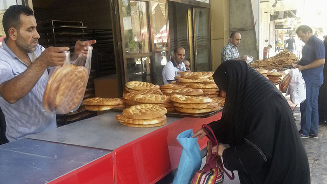 A woman buys bread at a bakery in the city of Mosul A woman buys bread at a bakery in the city of Mosul, June 24, 2014. U.S. Secretary of State John Kerry held crisis talks with leaders of Iraq's autonomous Kurdish region on Tuesday urging them to stand with Baghdad in the face of a Sunni insurgent onslaught that threatens to dismember the country. Picture taken June 24, 2014. REUTERS/Stringer (IRAQ - Tags: CIVIL UNREST POLITICS CONFLICT BUSINESS FOOD SOCIETY) - RTR3VNJJ