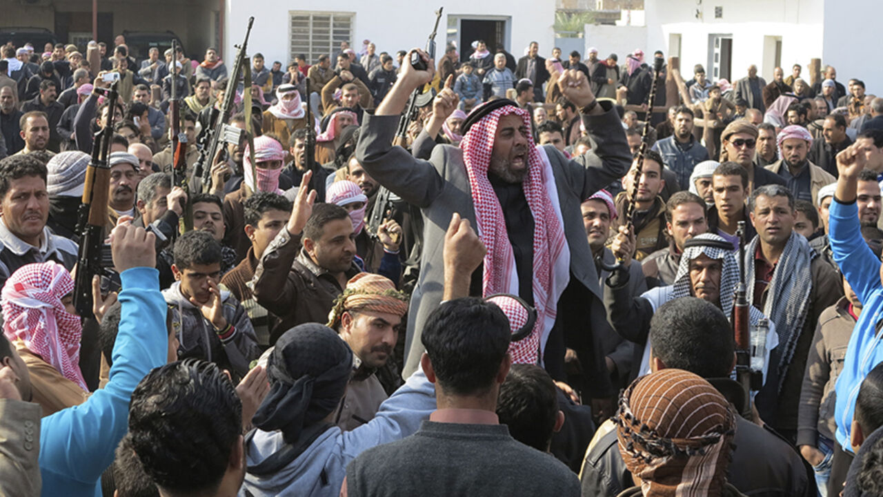 Residents gather to protest near the house of Alwani, in Ramadi Residents gather to protest near the house of prominent Sunni Muslim lawmaker Ahmed al-Alwani, in the centre of Ramadi, December 29, 2013. Iraqi security forces arrested Alwani in a raid on his home in the western province of Anbar, sparking clashes in which at least five people were killed, police sources said. Picture taken December 29, 2013. REUTERS/Ali al-Mashhadani (IRAQ - Tags: POLITICS CIVIL UNREST) - RTX16X7M