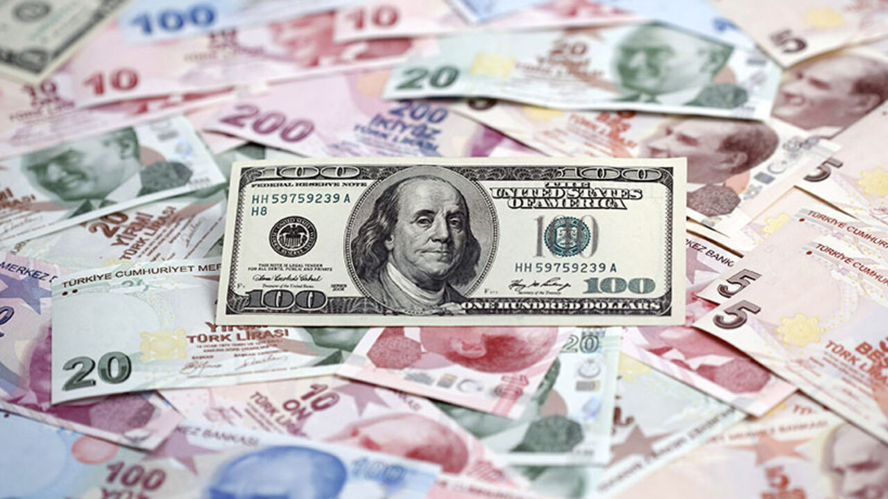 A photo illustration shows a U.S. 100 dollar banknote against Turkish lira banknotes of various denominations A photo illustration taken in Istanbul shows a U.S. 100 dollar banknote against Turkish lira banknotes of various denominations January 7, 2014. Turkey's lira slipped against the U.S. dollar on Wednesday as the government bond yield curve, which had briefly inverted on Tuesday because of speculation about an emergency rate hike to rescue the currency, returned to a positive slope. Picture taken January 7, 2014. REUTERS/Murad Sezer (TURKEY - Tags: BUSINESS) - RTX1761E