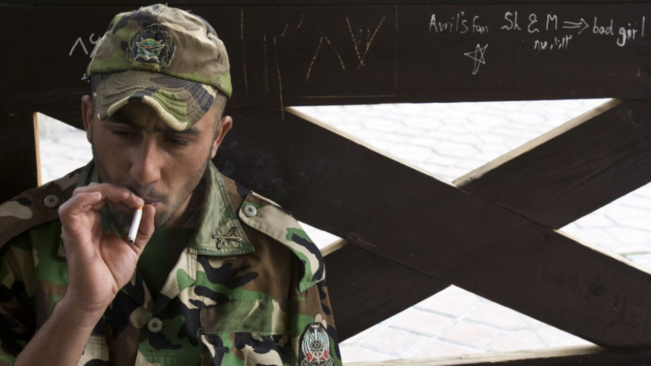 Member of Iranian army smokes as he rests at a park in central Tehran A member of the Iranian army smokes as he rests at a park in central Tehran, April 9, 2009. Reform minded youth see America as the land of opportunity and would like to see ties with the U.S. restored but conservative minded youth see the U.S. as the enemy and feel that the Islamic Revolution's goals must be kept alive. REUTERS/Raheb Homavandi (IRAN) - RTXDXV8