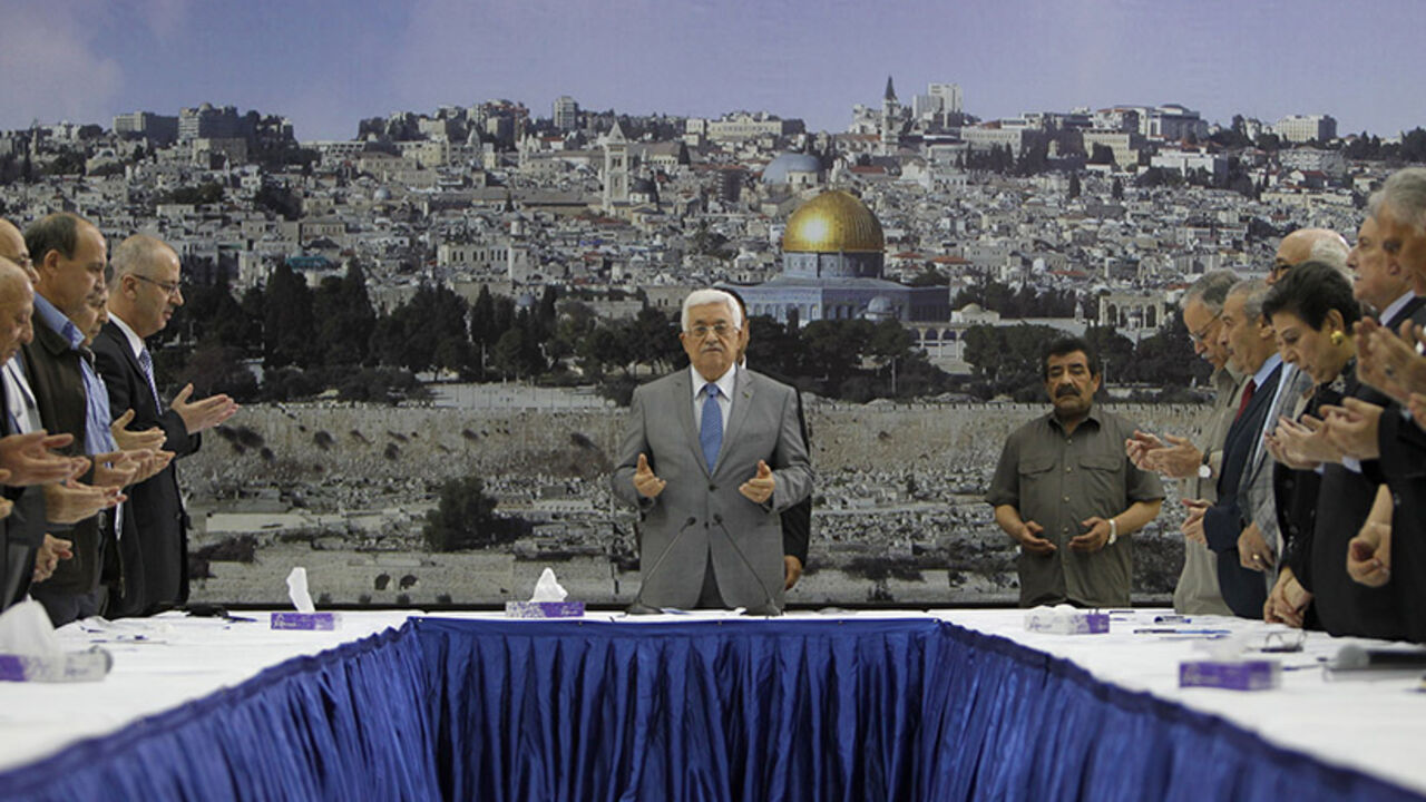 PALESTINIAN-ISRAEL-CONFLICT-ABBAS Palestinian president Mahmud Abbas (C) prays prior a meeting with his leadership in the West Bank city of Ramallah on July 9, 2014. Abbas has demanded Israel "immediately stop" its air campaign on the Gaza Strip and called on the international community to pressure the Jewish state. Israeli warplanes pounded targets in the Gaza Strip today as a major campaign to stop volleys of Palestinian rocket fire entered its second day. AFP PHOTO / ABBAS MOMANI (Photo credit should read ABBAS MOMANI/AFP/Getty Im
