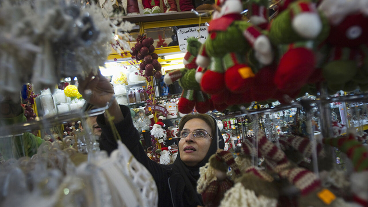 Iranian-Christian woman looks at Christmas decorations while shopping in central Tehran An Iranian-Christian woman looks at Christmas decorations while shopping in central Tehran December 13, 2011. REUTERS/Morteza Nikoubazl (IRAN - Tags: SOCIETY RELIGION) - RTR2V75E