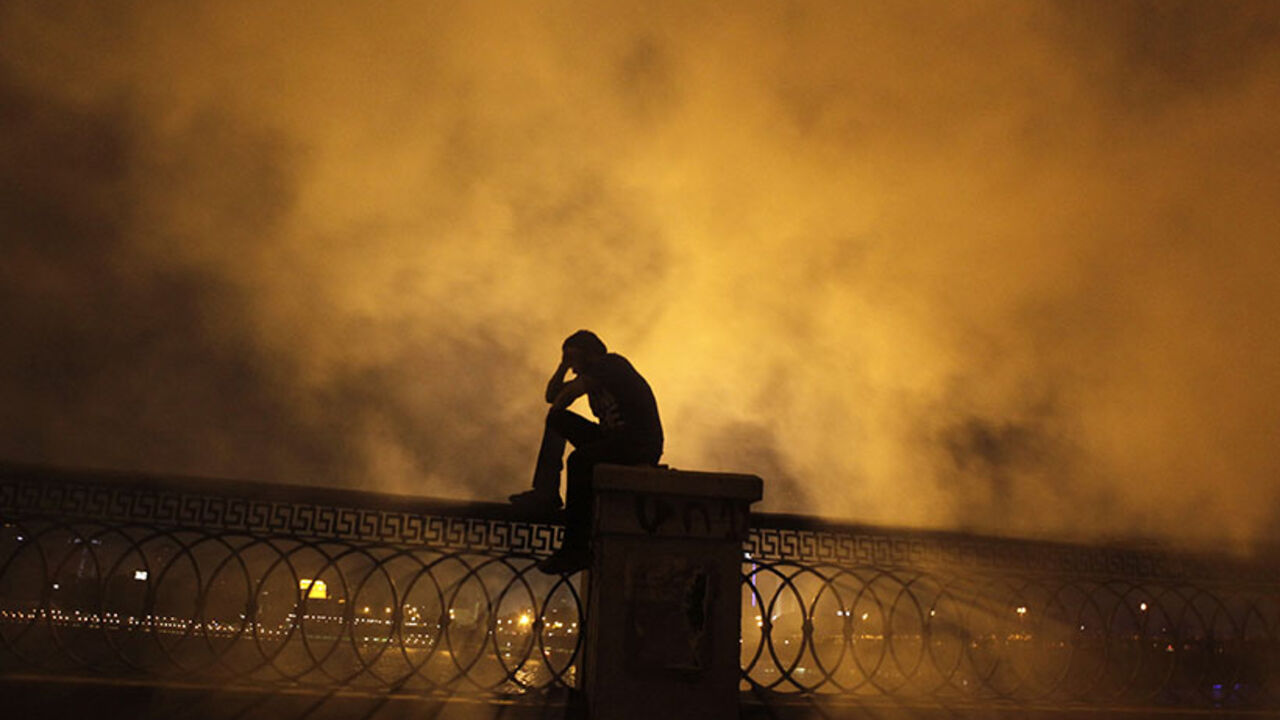 A protester covers his face as he stands in front of tear gas during clashes with riot police along a road at Kornish El Nile which leads to the U.S. embassy, near Tahrir Square in Cairo A protester covers his face as he stands in front of tear gas during clashes with riot police along a road at Kornish El Nile which leads to the U.S. embassy, near Tahrir Square in Cairo September 15, 2012. Clashes near the U.S. Embassy in central Cairo between police and Egyptians incensed over a film denigrating the Prophet Mohammad entered their fourth day early on Saturday, leaving one protester dead and dozens more injured. REUTERS/Amr Abdallah Dalsh (EGYPT - Tags: POLITICS CIVIL UNREST RELIGION) - R