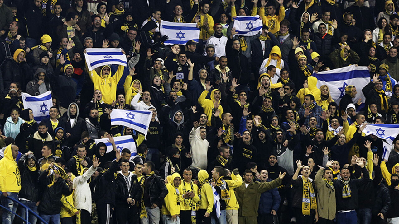 Supporters of Beitar Jerusalem cheer for their team during a soccer match against Maccabi Umm el-Fahm in Jerusalem Supporters of Beitar Jerusalem cheer for their team during a soccer match against Maccabi Umm el-Fahm at Teddy Stadium in Jerusalem January 29, 2013. Hundreds of police officers and stewards secured the Israeli State Cup match on Tuesday in which Premier League Beitar Jerusalem, supported by a group of vehement anti-Arab fans, host Arab side Maccabi Umm el-Fahm. A racist element among Beitar fans caused uproar in the Jewish state on Saturday when they held up banners during a Premier League match to protest