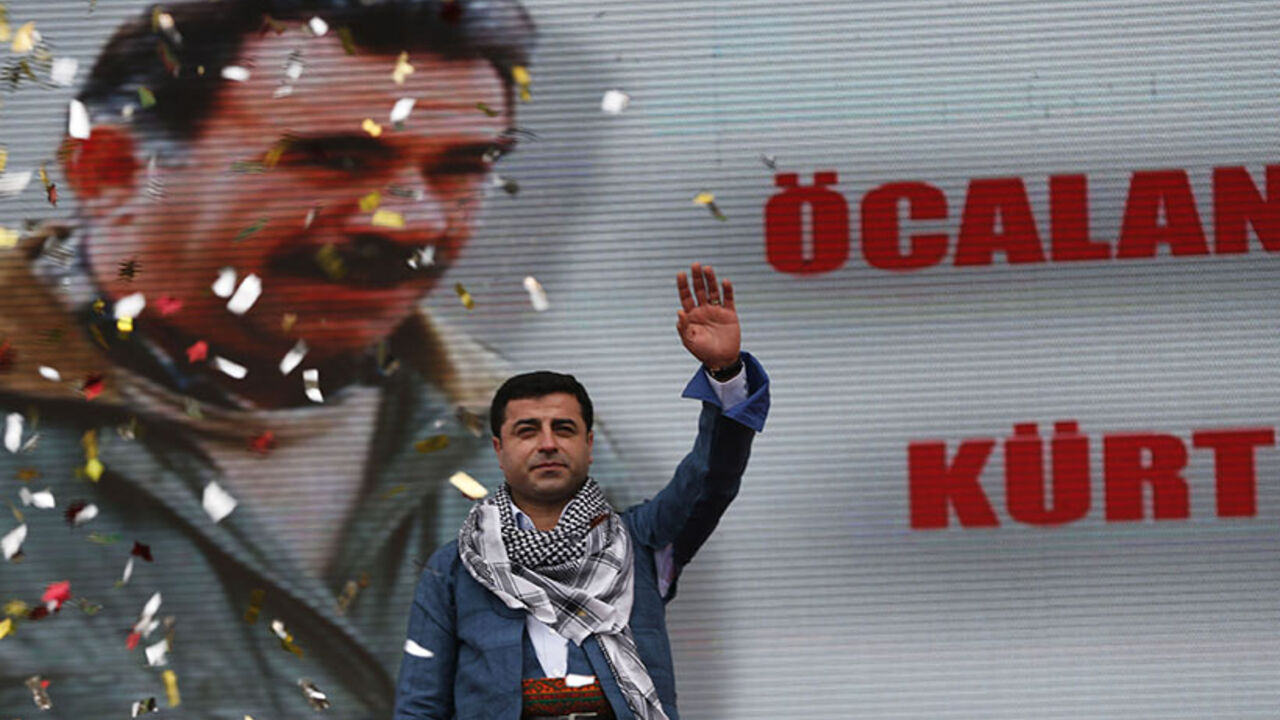 Demirtas, co-chairman of the pro-Kurdish Peace and Democracy Party, greets his supporters during a rally to celebrate the spring festival of Newroz in Istanbul Selahattin Demirtas, co-chairman of the pro-Kurdish Peace and Democracy Party, greets his supporters during a rally to celebrate the spring festival of Newroz in Istanbul March 17, 2013. A picture of imprisoned PKK leader Abdullah Ocalan is seen in the background. REUTERS/Murad Sezer (TURKEY - Tags: POLITICS CIVIL UNREST) - RTR3F4BY