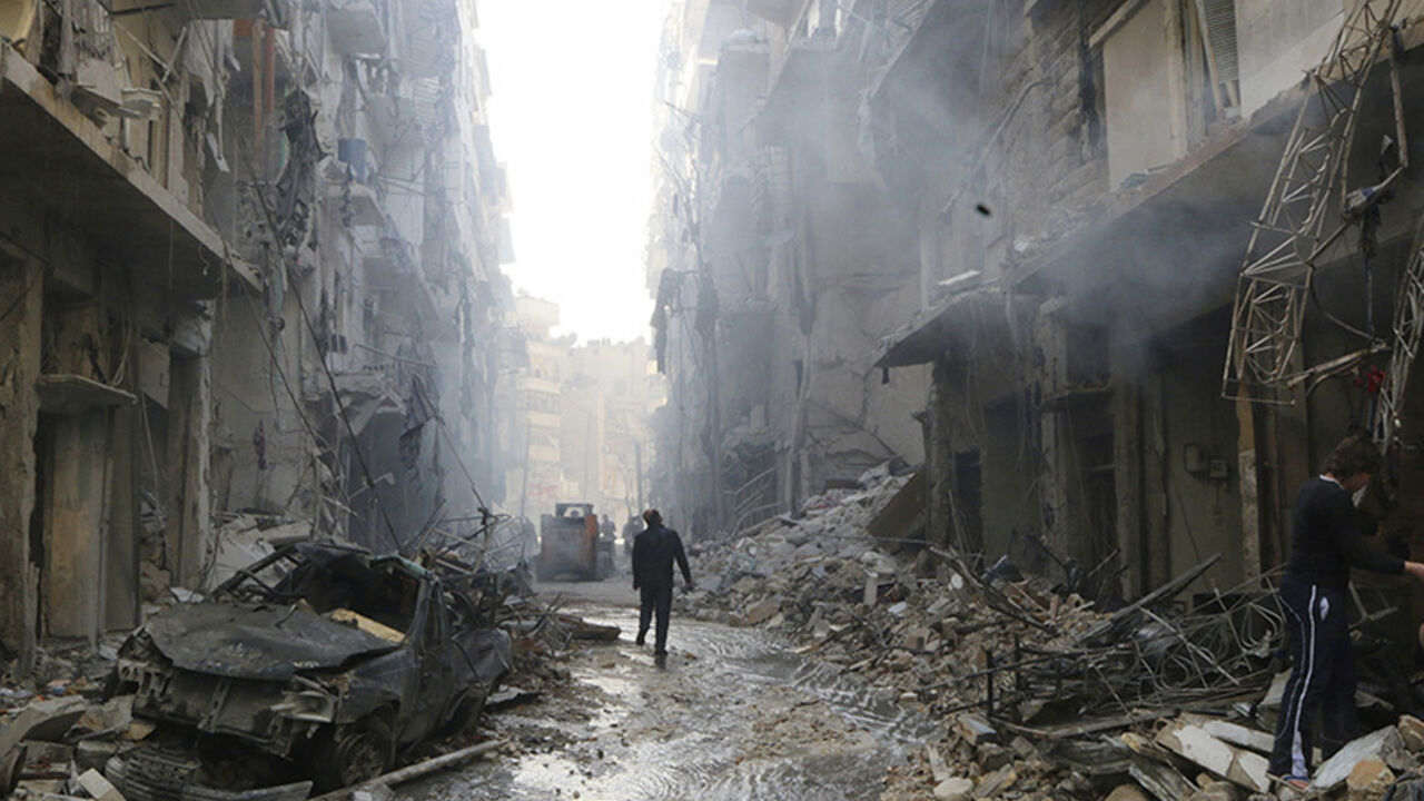People inspect damage at a site hit by what activists said were barrel bombs dropped by forces loyal to Syria's President al-Assad in Aleppo's district of al-Sukari People inspect damage at a site hit by what activists said were barrel bombs dropped by forces loyal to Syria's President Bashar al-Assad in Aleppo's district of al-Sukari March 7, 2014. REUTERS/Hosam Katan (SYRIA - Tags: CIVIL UNREST POLITICS TPX IMAGES OF THE DAY CONFLICT) FOR BEST QUALITY IMAGES ALSO SEE: GF2EA42122E01 - RTR3G63Q
