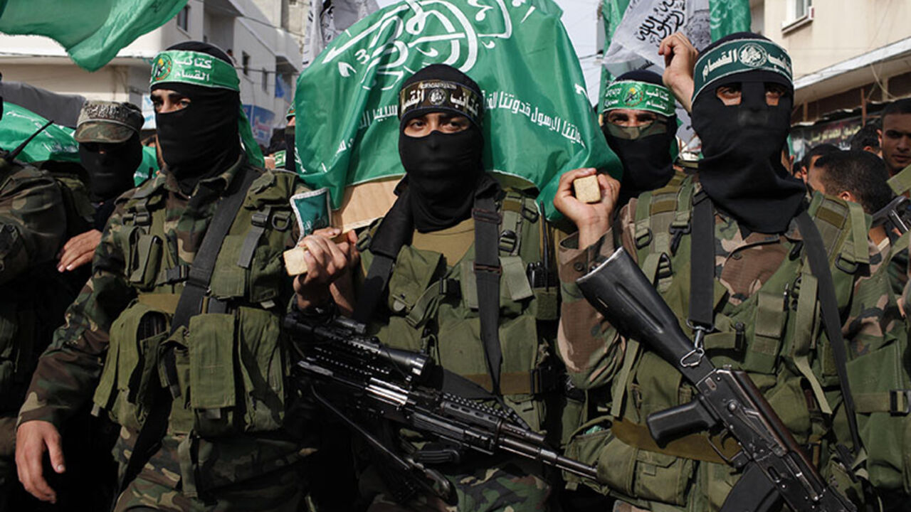 Palestinian Hamas militants carry a coffin containing the body of their comrade Rami Meshmish during his funeral in the central Gaza Strip Palestinian Hamas militants carry a coffin containing the body of their comrade Rami Meshmish during his funeral in the central Gaza Strip April 16, 2014. Meshmish and another fellow militant were killed in an accidental explosion on Wednesday; al-Qassam brigades, the armed wing of Hamas movement, said in a statement. REUTERS/Ibraheem Abu Mustafa (GAZA - Tags: POLITICS) - RTR3LJJR