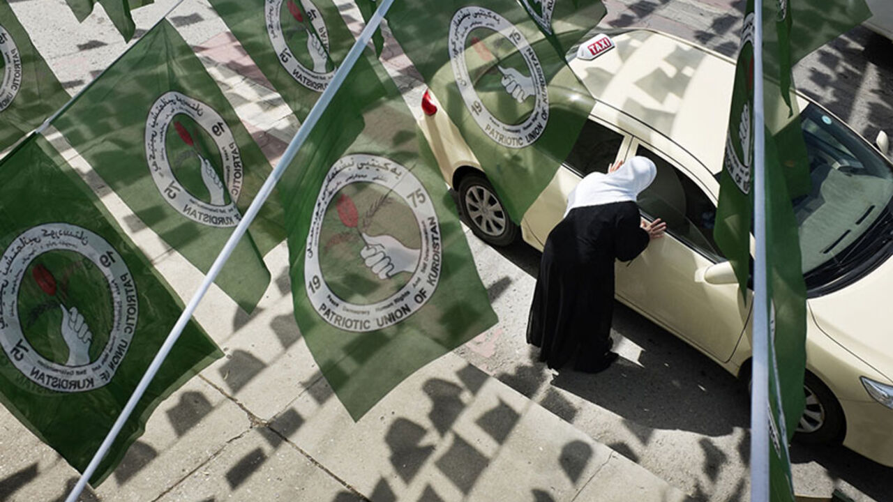 A woman hails a taxi while standing under PUK logos before Iraq's parliamentary elections in Sulaimaniya A woman hails a taxi while standing under Patriotic Union of Kurdistan (PUK) logos before Iraq's parliamentary elections in Sulaimaniya April 28, 2014. Picture taken April 28, 2014. To match IRAQ-ELECTION/KURDS REUTERS/Jacob Russell (IRAQ - Tags: ELECTIONS POLITICS) - RTR3N0GY