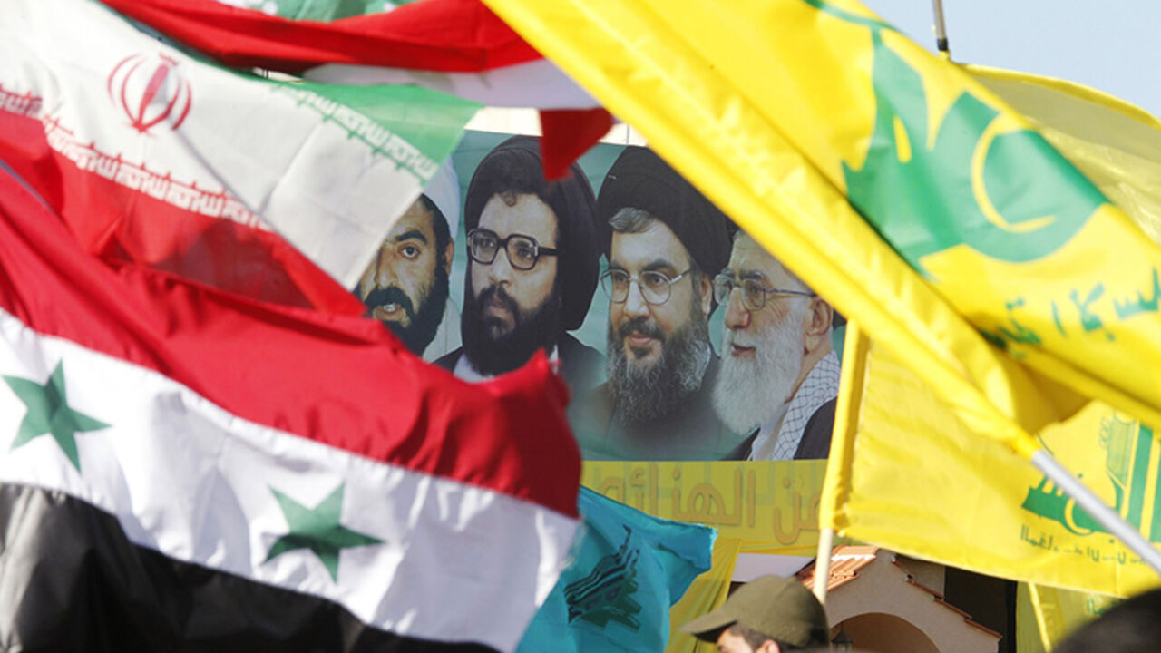 A poster of (R-L) Iran's supreme leader Ayatollah Ali Khamenei, Hezbollah Secretary-General Sayyed Hassan Nasrallah, former Hezbollah Secretary-General Sayyed Abbas al-Musawi and Lebanese resistance leader and cleric Sheikh Ragheb Harb, is seen in between Iranian, Syrian, Lebanese and Hezbollah flags during Resistance and Liberation Day celebrations in Bint Jbeil May 25, 2014. The event commemorates the 14th anniversary of Israel's withdrawal from southern Lebanon.  REUTERS/Ali Hashisho (LEBANON - Tags: POL