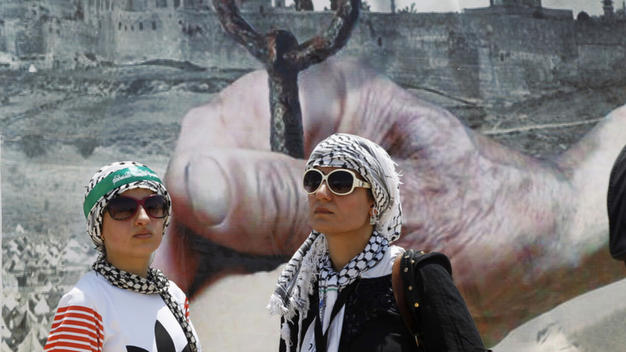 Women stand in front of poster depicting al-Aqsa mosque and Dome of the Rock during protest organised by Jordanian Islamic Action Front in Swaymeh Women stand in front of a poster depicting al-Aqsa mosque and the Dome of the Rock during a protest organised by the Jordanian Islamic Action Front in Swaymeh, at the Dead Sea area near the border between Jordan and Israel June 6, 2014. The protest is part of the Global March to Jerusalem initiative, marking the 47th anniversary of Israel's capture of East Jerusalem in the 1967 Middle East war. REUTERS/Majed Jaber (JORDAN - Tags: POLITICS CIVIL UNREST ANNIVERSARY) - RTR3SK3K