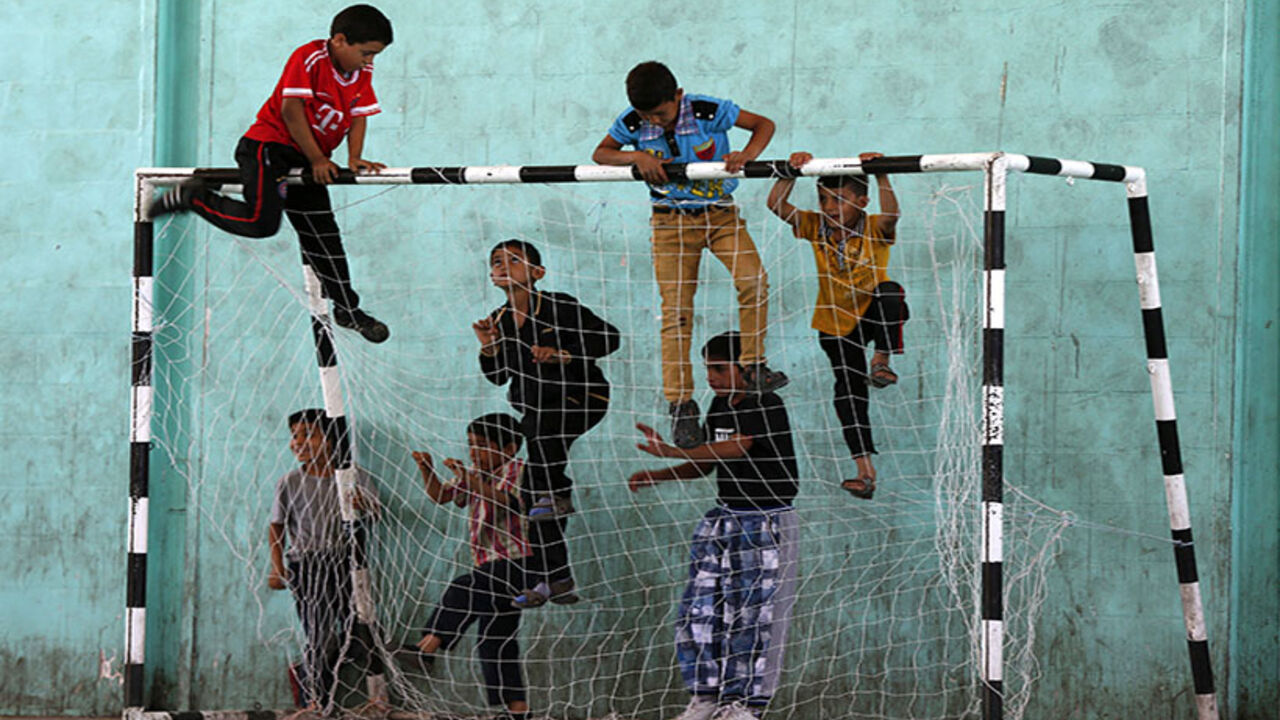 Refugee children play before start of a soccer match in the Al-Baqaa Palestinian refugee camp, near Amman Syrian and Palestinian refugee children climb up a goalpost before the start of a soccer match in the Al-Baqaa Palestinian refugee camp, near Amman June 17, 2014. The football league between young Syrian and Palestinian refugees and Jordanian youth is organized by Oxfam and the al-Baqaa youth club to commemorate World Refugee Day, which falls on June 20. The matches aim to foster positive relationships between communities, fighting exclusion and marginalization, while promoting trust and friendship, accordi