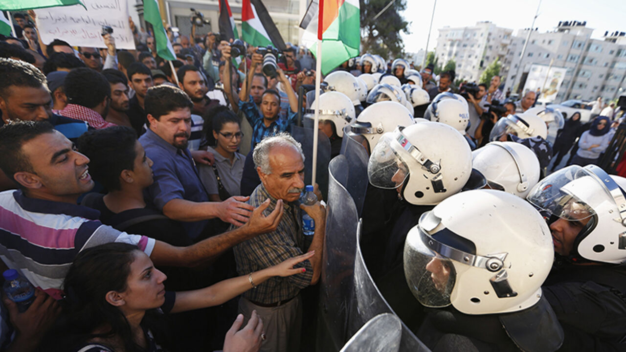Protesters argue with Palestinian riot police during protest against security coordination between Palestinian authority and Israel, in Ramallah Protesters argue with Palestinian riot police during a protest against security coordination between Palestinian authority and Israel, in the West Bank city of Ramallah June 23, 2014. Israeli troops killed two Palestinians on Sunday, Palestinian medics and a militant group said, as Israel pressed on with its crackdown on Hamas, the Islamist group it accuses of abducting three Israeli teenagers. Palestinian president Mahmoud Abbas has condemned the abduction of the three Israelis, and his security forces hav